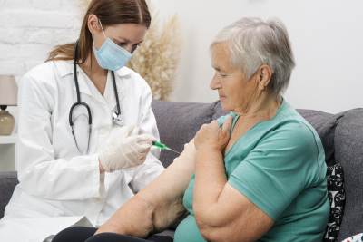 nurse injecting an elderly