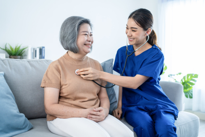 nurse checking an elderlies heart rate