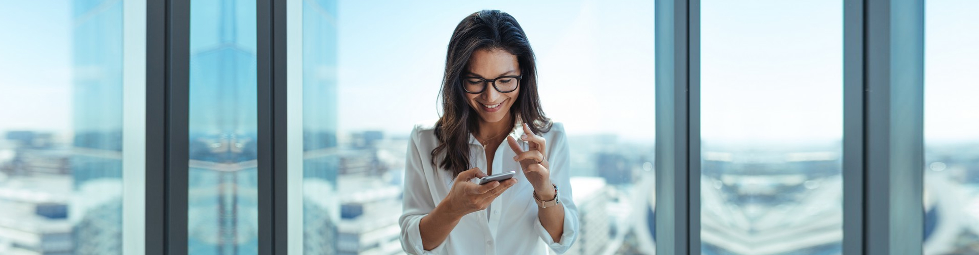 woman looking at phone smiling