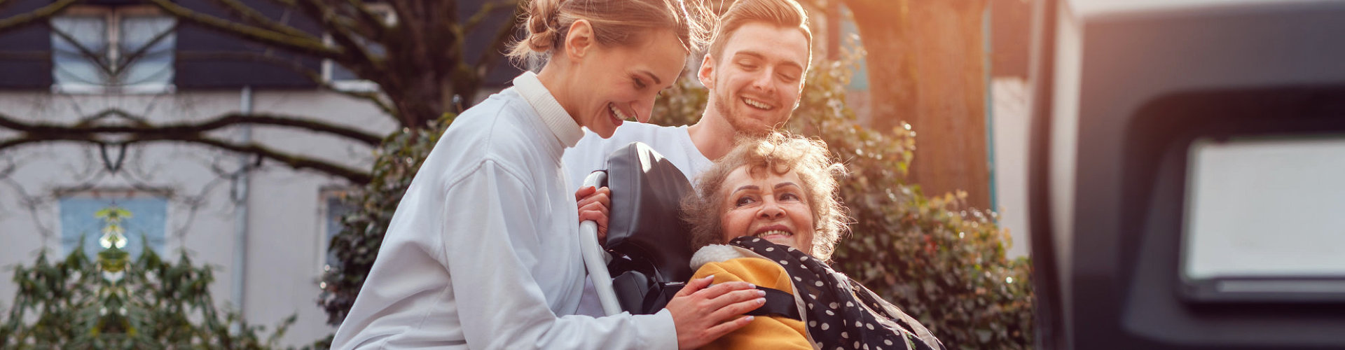 nurses pushing senior woman's wheelchair