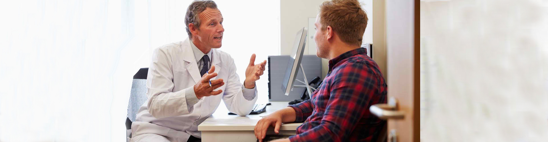 doctor talking to male patient